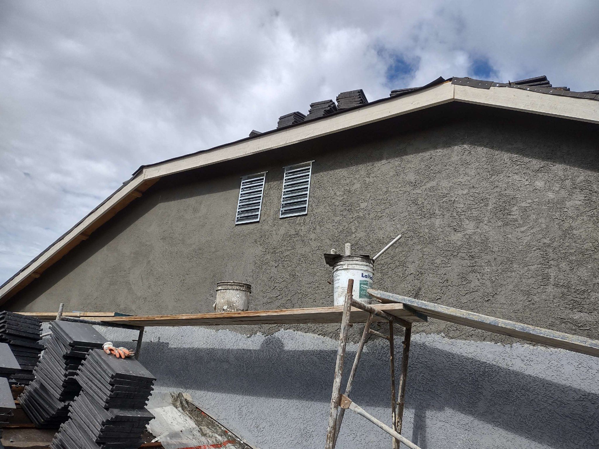 Stucco exterior wall repair with scaffolding