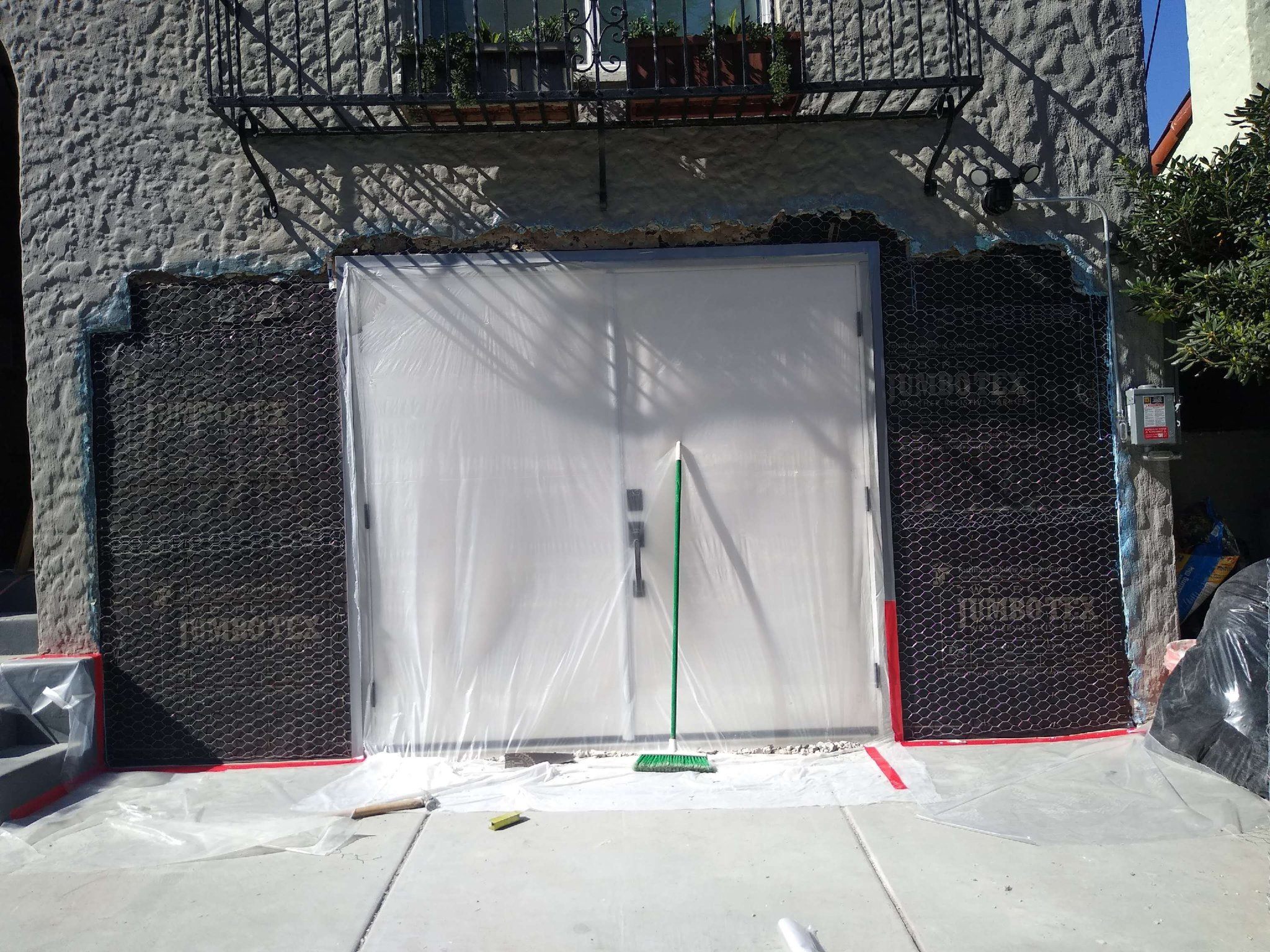 Stucco repair around a garage opening